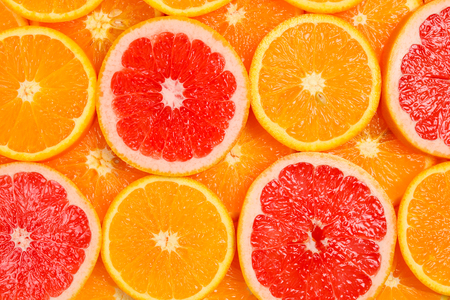 Slices of oranges and a grapefruits as a background.の写真素材