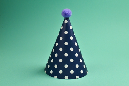 Colorful birthday cap on a green background.の写真素材