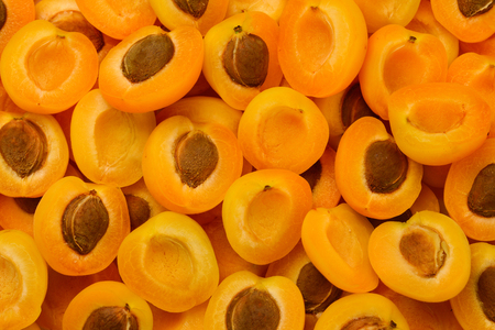Ripe juicy orange apricots slices fruit background. の写真素材