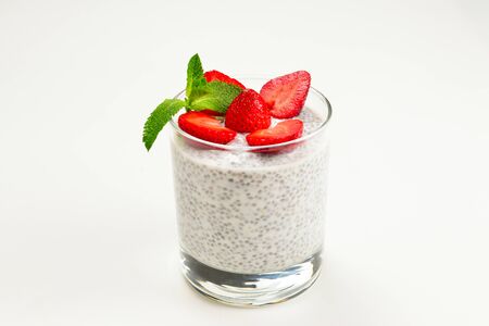 Chia pudding with strawberry and mint on a white background. Space for text or design.の写真素材