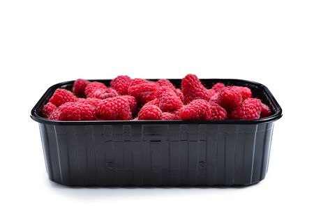 Raspberry in black container isolated on white background.