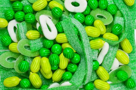 Assorted green gummy candies background. Top view. Jelly  sweets.の写真素材