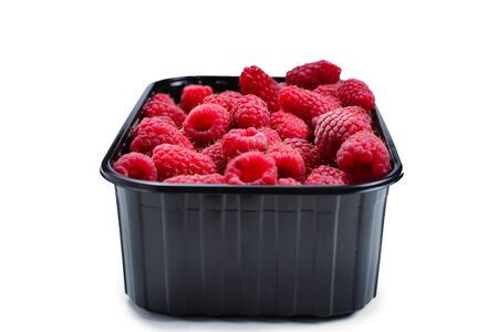 Raspberry in black container isolated on white background.の写真素材