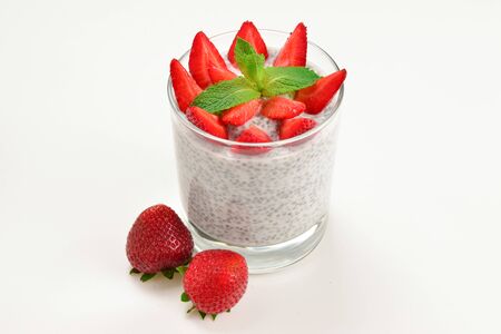 Chia pudding with strawberry and mint on a white background. Space for text or design.の写真素材