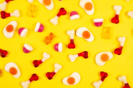Assorted jelly sweets on yellow background. Pattern.の写真素材