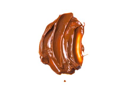 Melted tasty caramel splashes isolated on white background.の写真素材