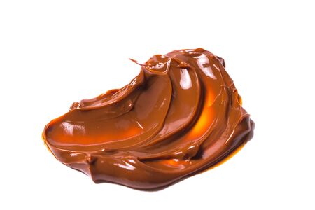 Melted tasty caramel splashes isolated on white background.の写真素材