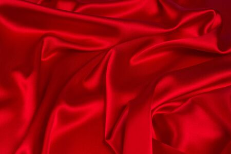 Red silk or satin luxury fabric texture can use as abstract background. Top view.の写真素材