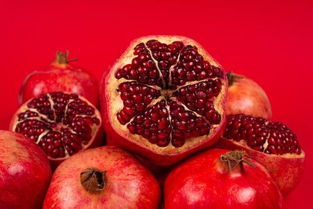 Sweet pomegranate on red background. Top view.