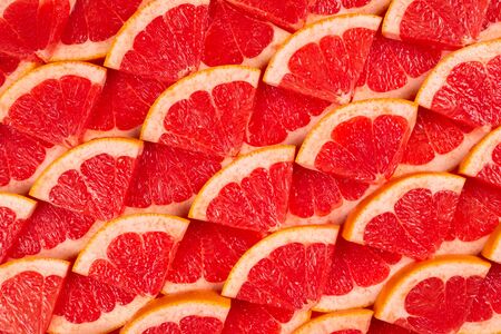 Grapefruit red juicy slices background. top view.の写真素材