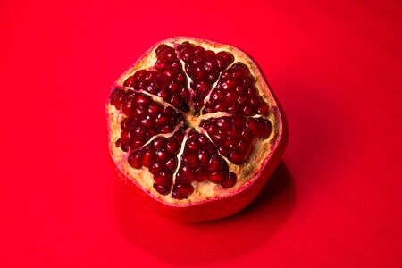 Sweet pomegranate on red background.の写真素材