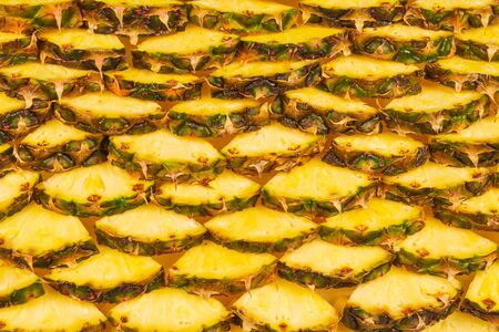 Pineapple juicy yellow slices background. Top view.の写真素材