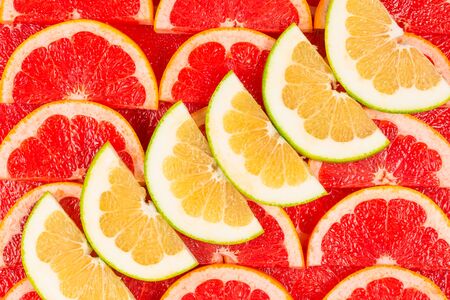 Pomelo and grapefruit juicy slices background. の写真素材