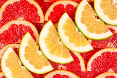 Pomelo and grapefruit juicy slices background.の写真素材