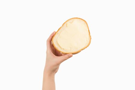 Tasty bread and butter in woman hand isolated on white background.