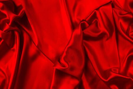 Red silk or satin luxury fabric texture can use as abstract background. Top view.の写真素材