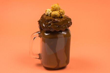 Chocolate milkshake with whipped cream, cookies, waffles, served in glass mason jar. "Freak or crazy" sweet shake. Space for text or design.の写真素材