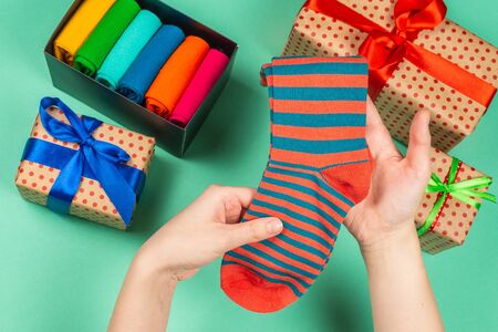 Colorful collection of cotton socks as a gift in woman hands. Gift.の写真素材