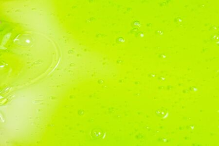 Green slime toy in woman hand isolated on white. Top view. の写真素材