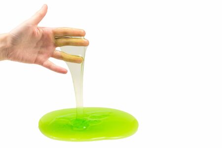 Green slime toy in woman hand isolated on white.