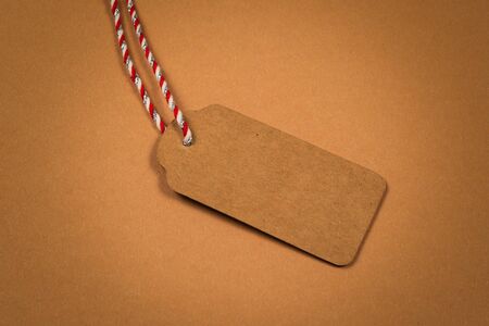 Brown empty tag on brown background. Copy space. の写真素材