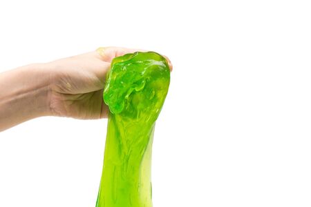 Green slime toy in woman hand isolated on white.の写真素材
