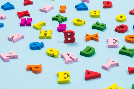 Multicolored letters on a blue background. Top view.の写真素材