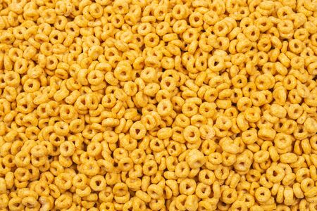 Corn-flakes background and texture. Top view. Honey rings cereal box for morning breakfast.の写真素材