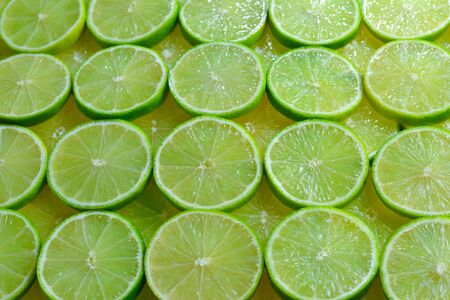 Fresh lime slices as a background. の写真素材
