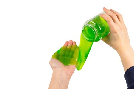Green slime toy in woman hand isolated on white. Top view.の写真素材