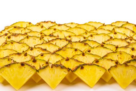 Pineapple juicy yellow slices background. Top view.の写真素材
