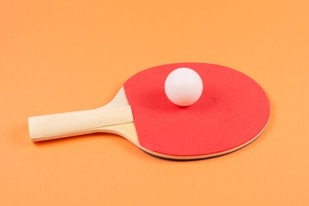 Pin pong on an orange background.  Top view.