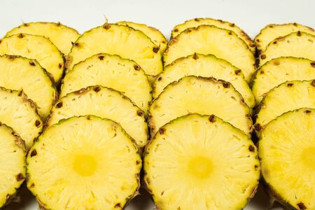 Pineapple juicy yellow slices background. Top view.の写真素材