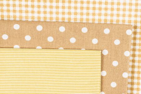 Mix of beige, white and brown cotton fabric. Top view.
