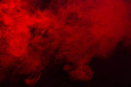 Red steam on a black background. Copy space.