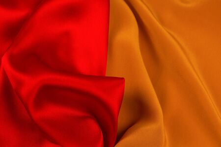 Red and orange silk or satin luxury fabric texture can use as abstract background. Top view.の写真素材
