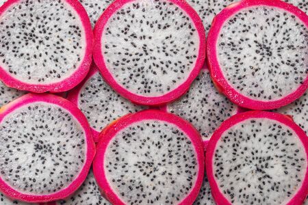 Sweet tasty dragon fruit or pitaya slices as a background.の写真素材