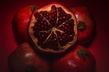 Sweet pomegranate on red background. Top view.の写真素材