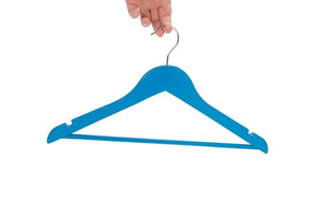 Blue hanger in woman hand isolated on white background.の写真素材