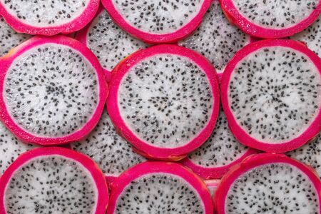 Sweet tasty dragon fruit or pitaya slices as a background.の写真素材