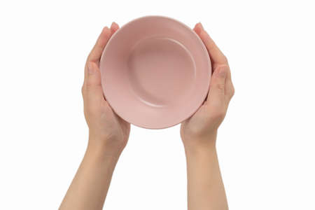 Pink dish in woman hands isolated on white background.の写真素材