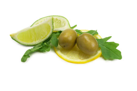 Two olives, piece of lemon and leaves of arugula isolated on white background.の写真素材