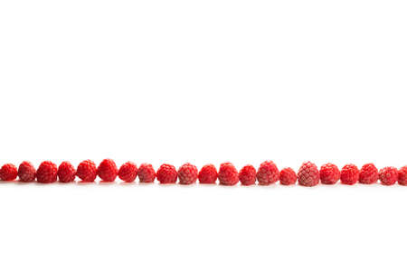 Raspberries in a row isolated on white background.