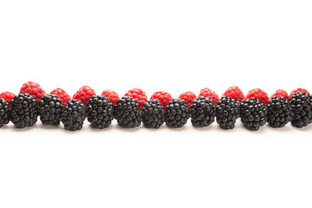 Raspberries in a row isolated on white background.