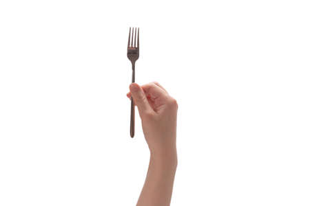 Fork in woman hand isolated on white background.の写真素材