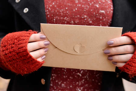 Woman holding a vintage envelope in hands.の写真素材