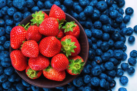 Blueberries and strawberries background. Top view.の写真素材