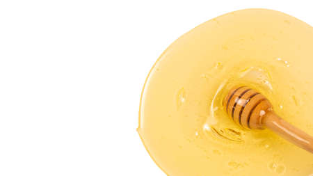 Dipper with honey on a white background. Space for text or design.の写真素材