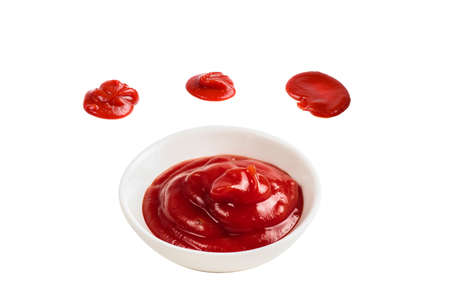 Ketchup in white plate on white background.の写真素材