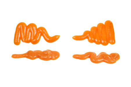 Orange sauce splashes isolated on white backgroundの写真素材